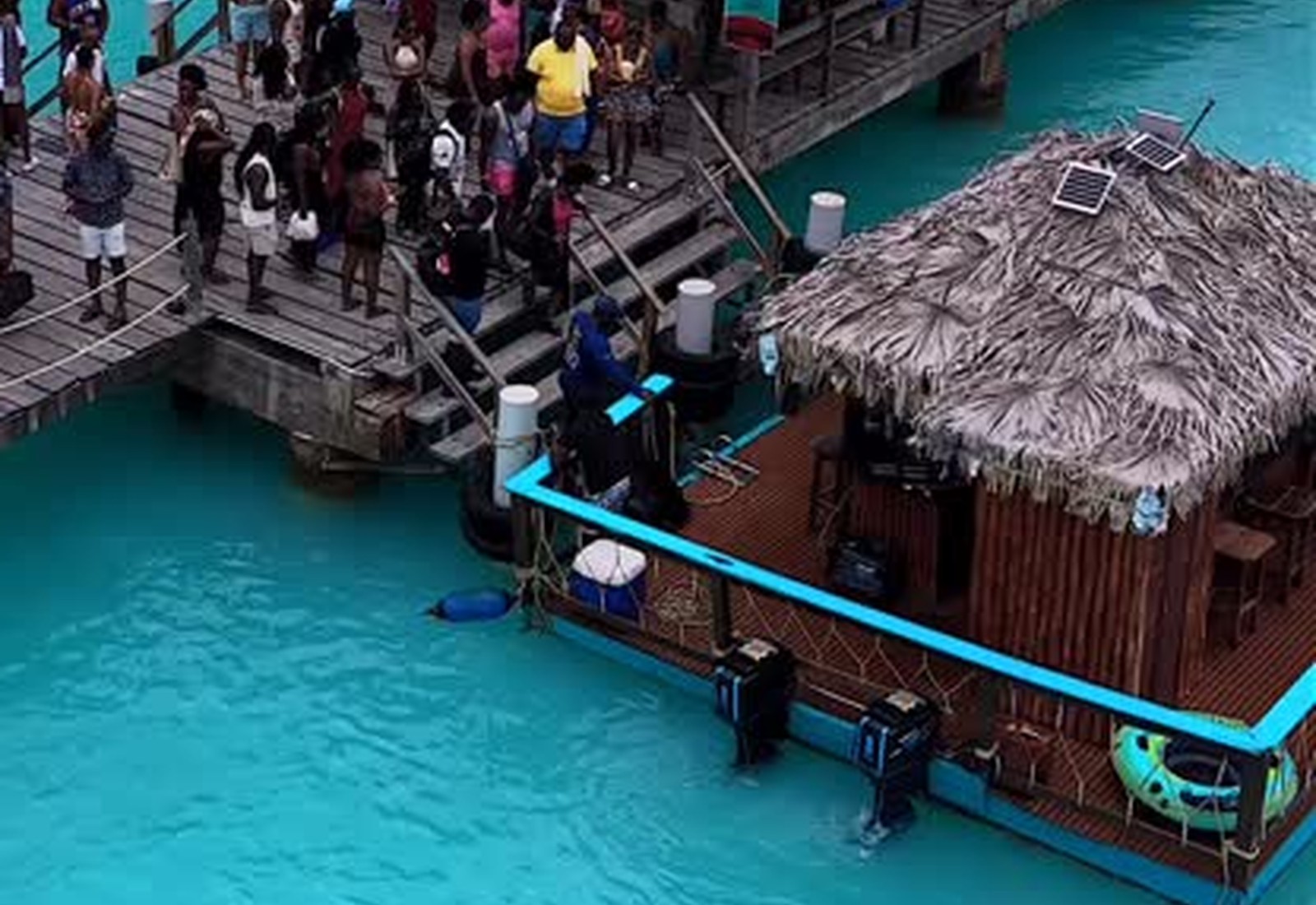 Tiki Tiki Bago floating boat bar docked at turquoise water, Tobago